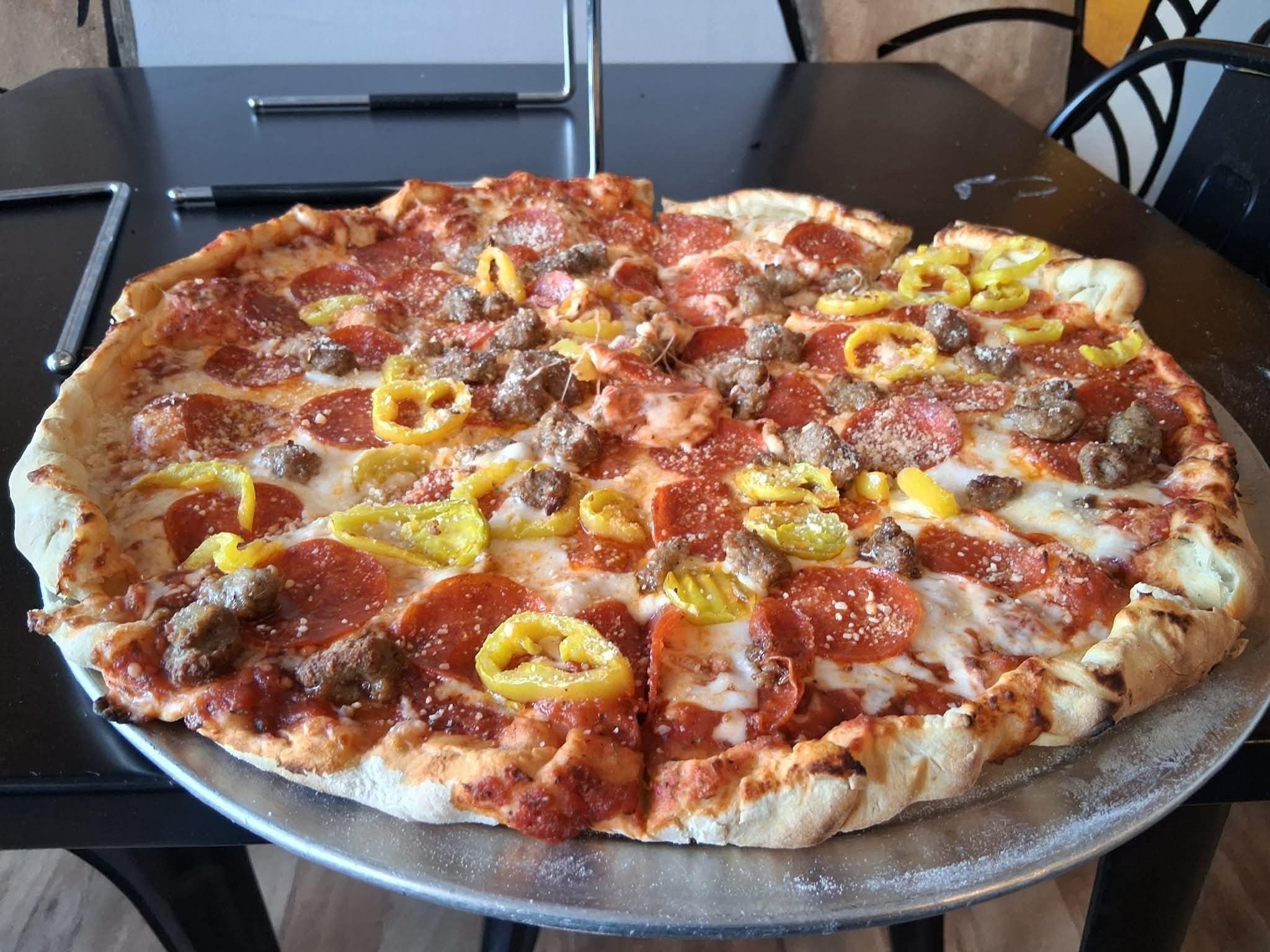The Lockdown pizza with pepperoni, sausage, and banana peppers